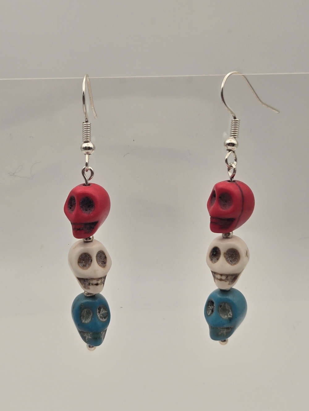 Tricolor Skull Dangle Howlite Earrings — Red, White & Blue